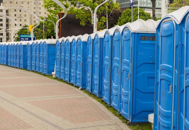 a row of portable restrooms set up for a large athletic event, allowing participants and spectators to easily take care of their needs in Brownsville